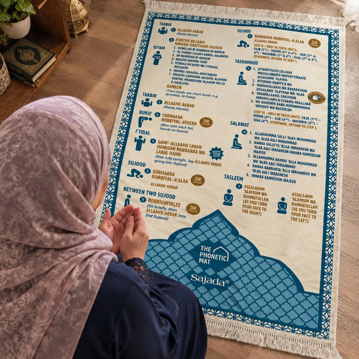 Woman using the printed phonetic Salah mat during a quiet prayer learning session